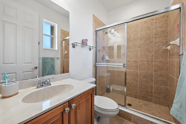 a bathroom with a toilet and a shower