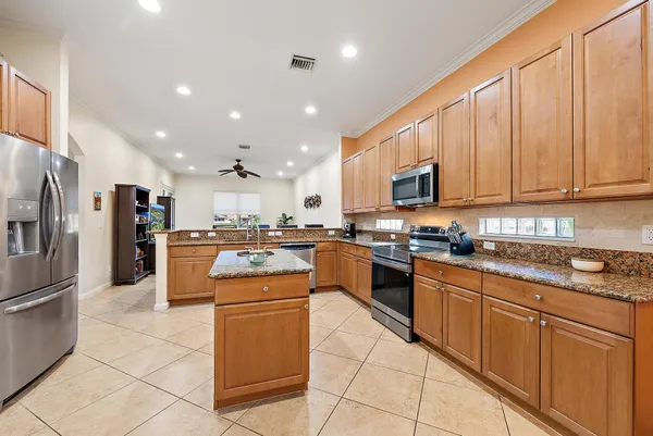 a kitchen with stainless steel appliances granite countertop a refrigerator and a sink
