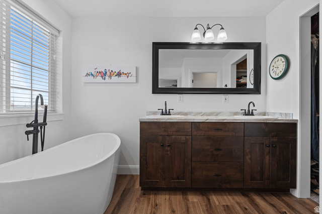 75 North 100th Street West Fillmore, UT 84631 - Photo 14 of 62 Full bath featuring double vanity, a freestanding tub, and dark wood-type flooring
