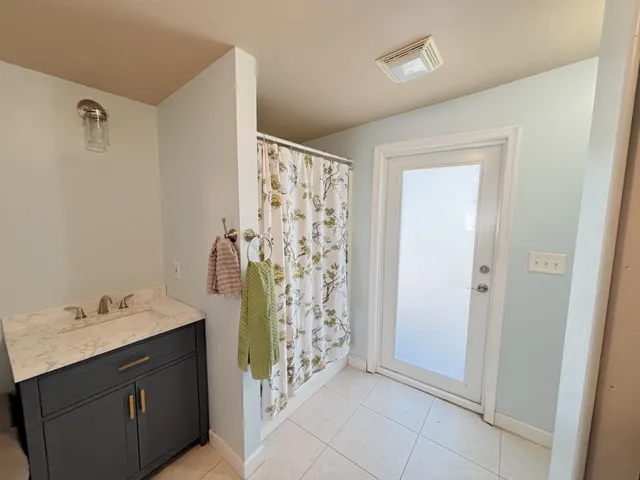 a spacious bathroom with a shower and a sink