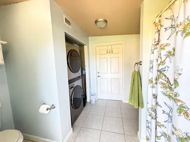 a view of a bathroom with washing machine and dryer