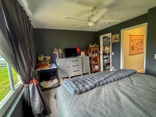 a bedroom with a bed and a dresser