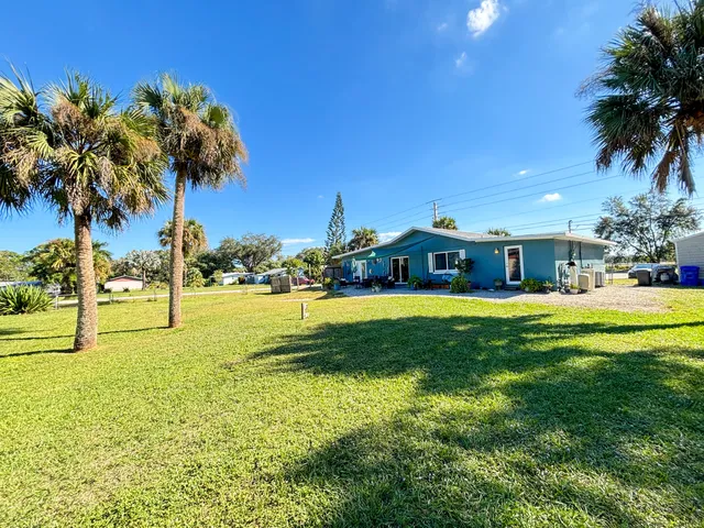 a swimming pool with outdoor seating and yard