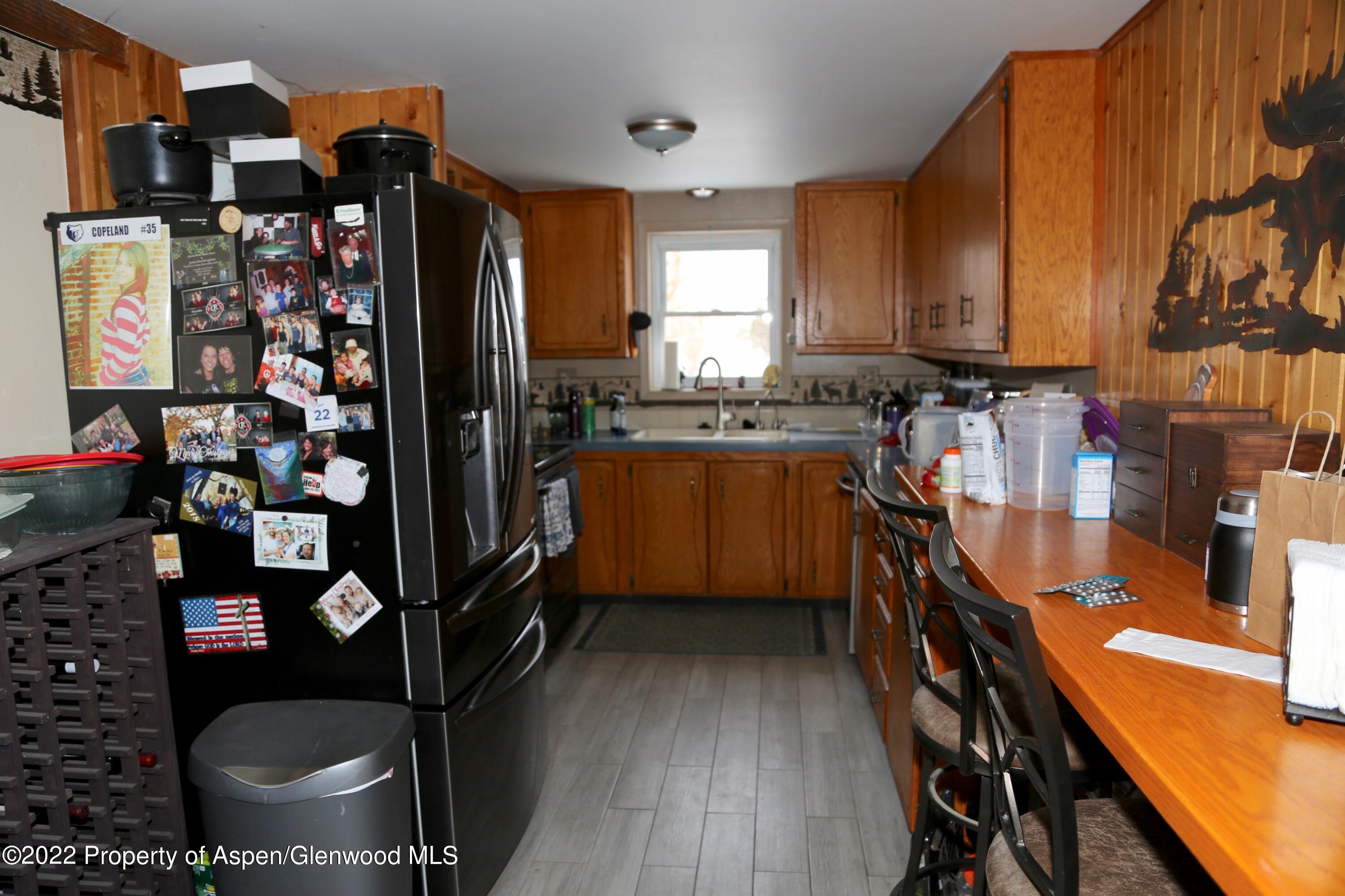 756 County Road 221 Rifle, CO 81650 - Photo 14 of 15 a kitchen with lots of clutter and stainless steel appliances
