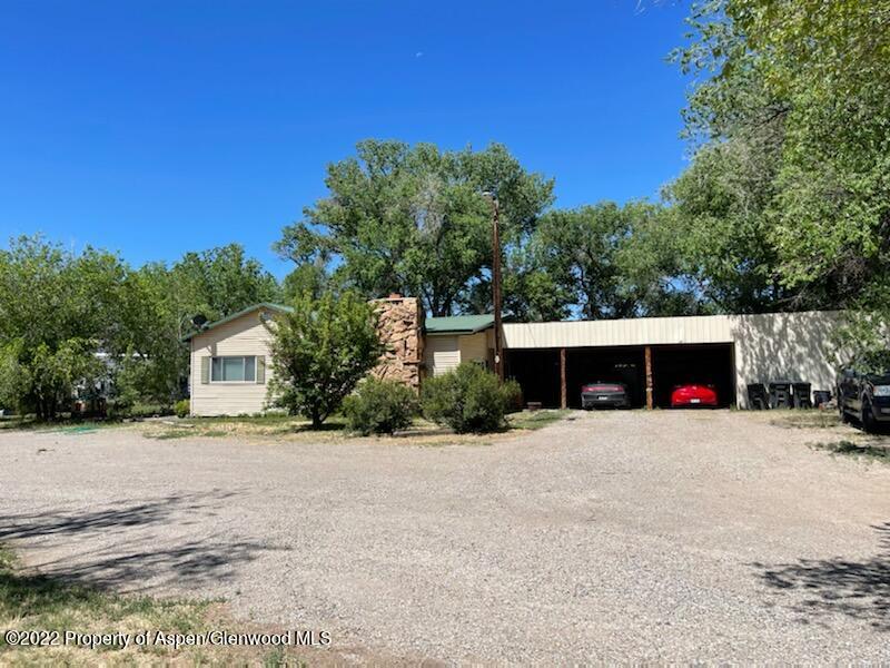 756 County Road 221 Rifle, CO 81650 - Photo 3 of 15 a front view of a house with a yard and garage