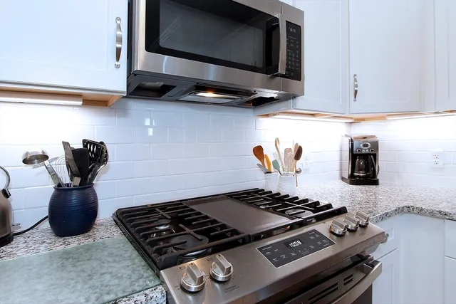 a stove top oven sitting inside of a kitchen