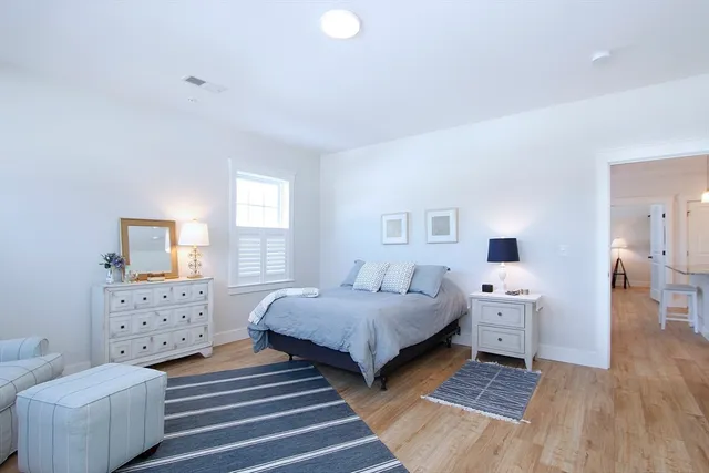 a bedroom with two beds and a dresser