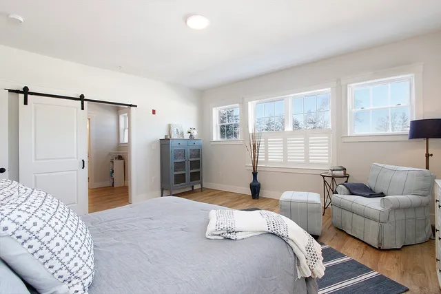 a bedroom with a bed and a couch