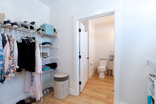 a bathroom with a granite countertop toilet sink and mirror
