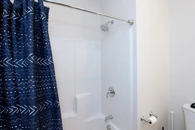 a bedroom with furniture and a wooden floor