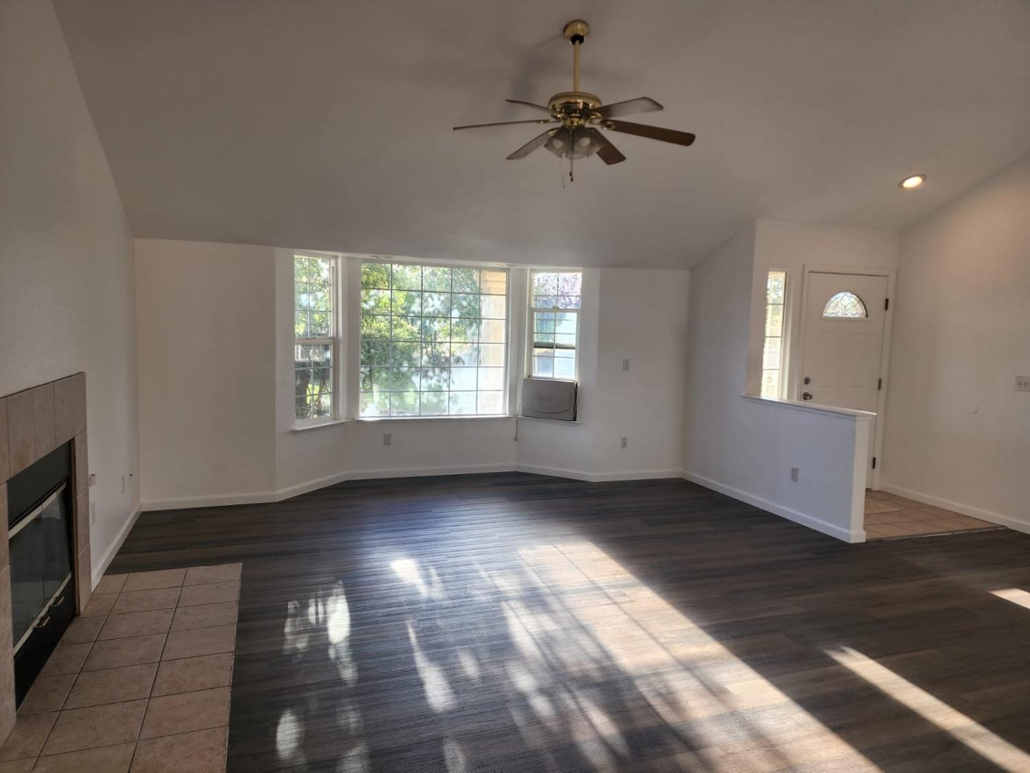 17313 Road 26 Madera, CA 93638 - Photo 4 of 15 a view of an empty room with a window and wooden floor