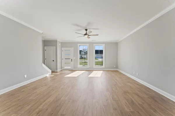 wooden floor in an empty room with a window