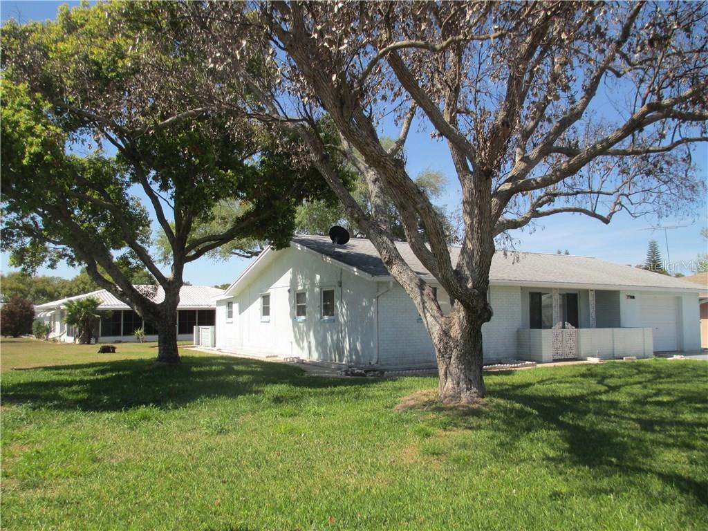 7708 Lotus Drive Port Richey, FL 34668 - Photo 1 of 1 BEAUTIFUL CORNER LOT WITH NATURAL SHADE FROM THE FLORIDA SUN.