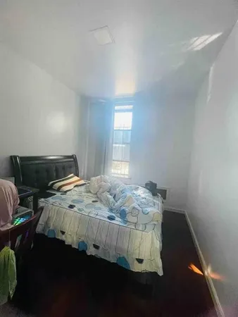 a bed sitting in a bedroom next to a window