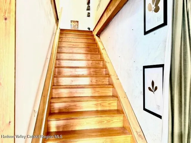a very nice looking living room with a large window and a dining table with chairs