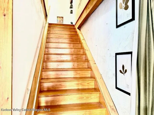 a very nice looking living room with a large window and a dining table with chairs