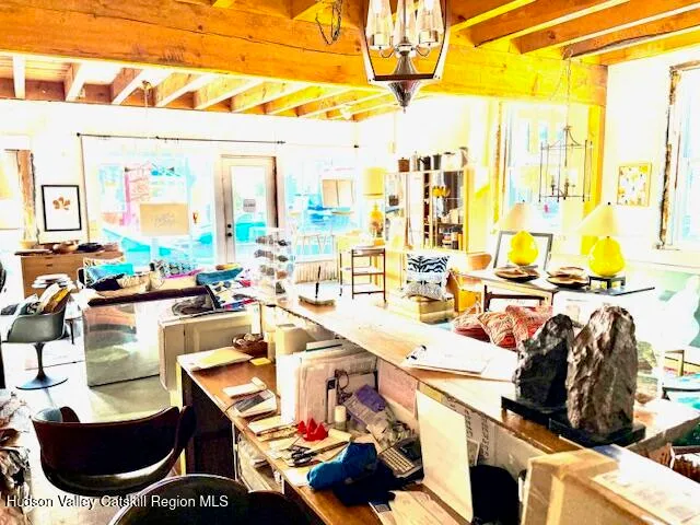 a living room with lots of furniture and a view of kitchen