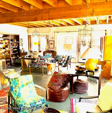 a room with furniture a rug and a window