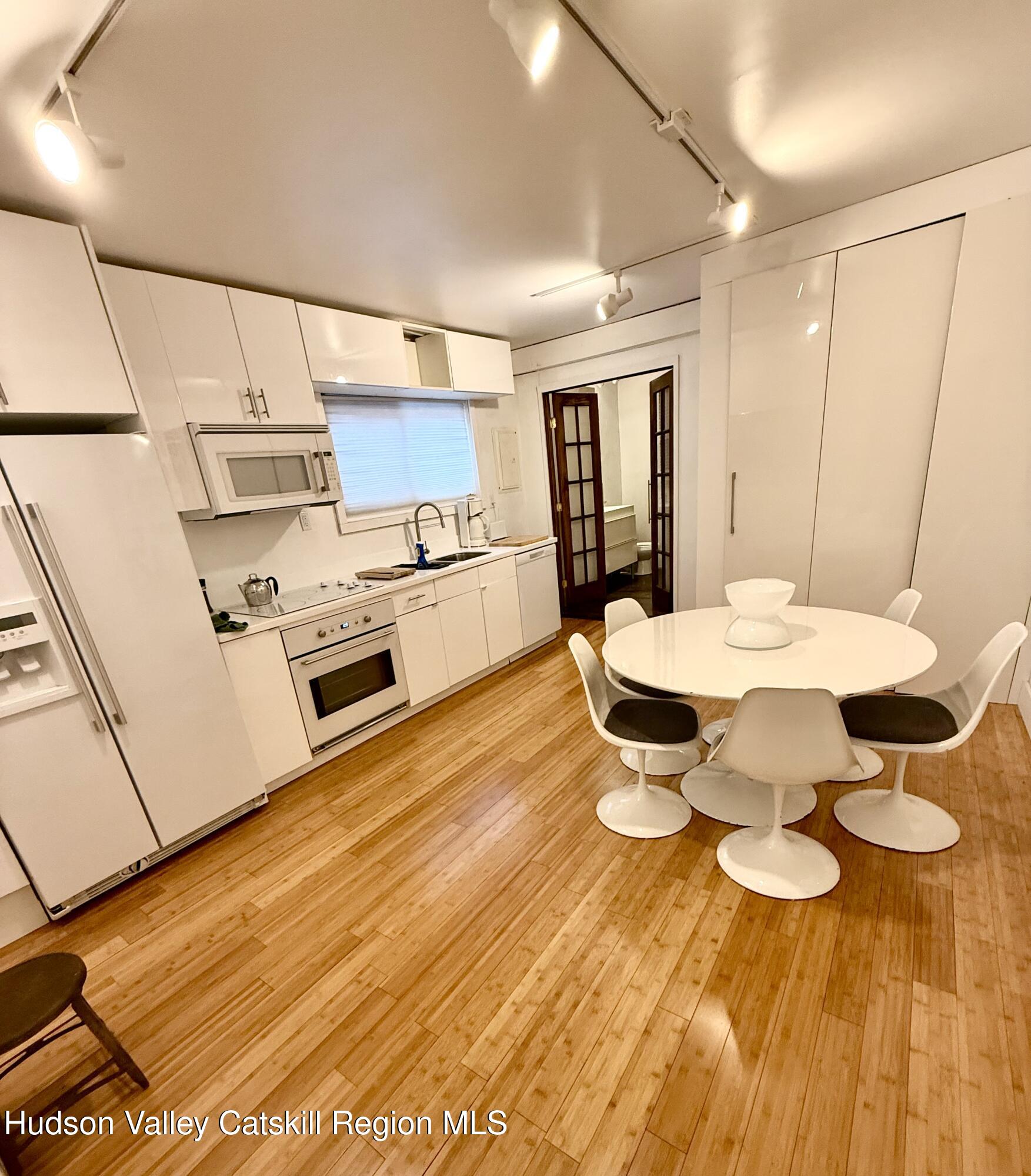92 Partition Street Saugerties, NY 12477 - Photo 23 of 25 a open kitchen with dining table and chairs