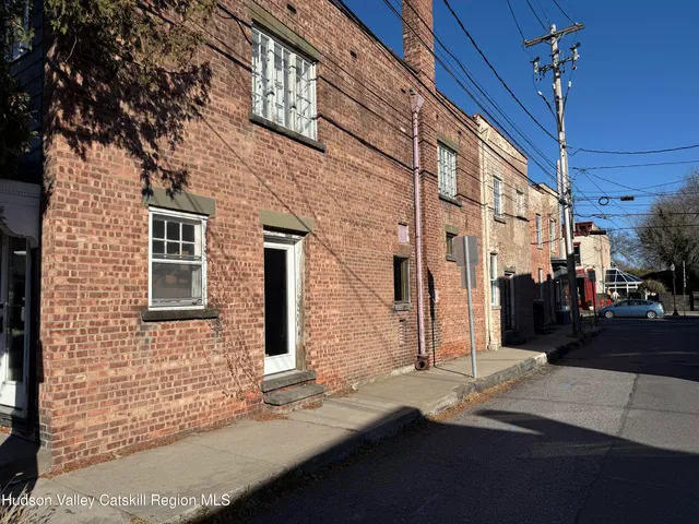 a view of a brick house with many windows