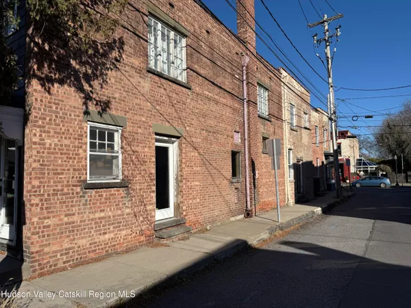 a view of a brick house with many windows