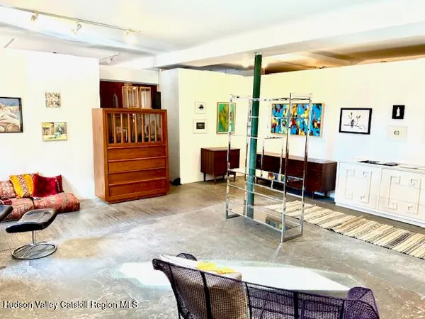 a living room with furniture a piano and a flat screen tv