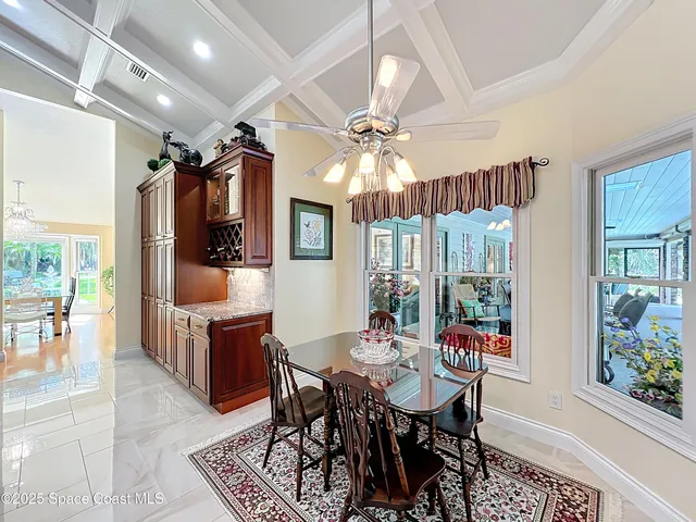 an aerial view of a house with a yard and trees all around
