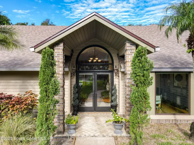 a bedroom with a large bed and a flat tv screen on a dresser