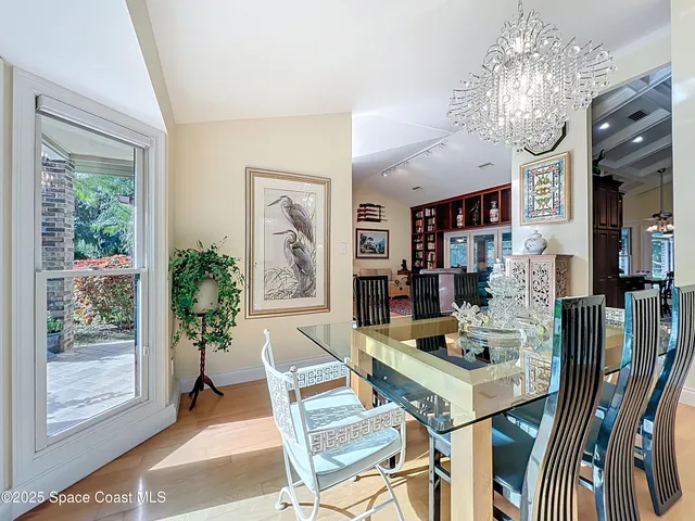 a dining room with furniture a rug and a large window