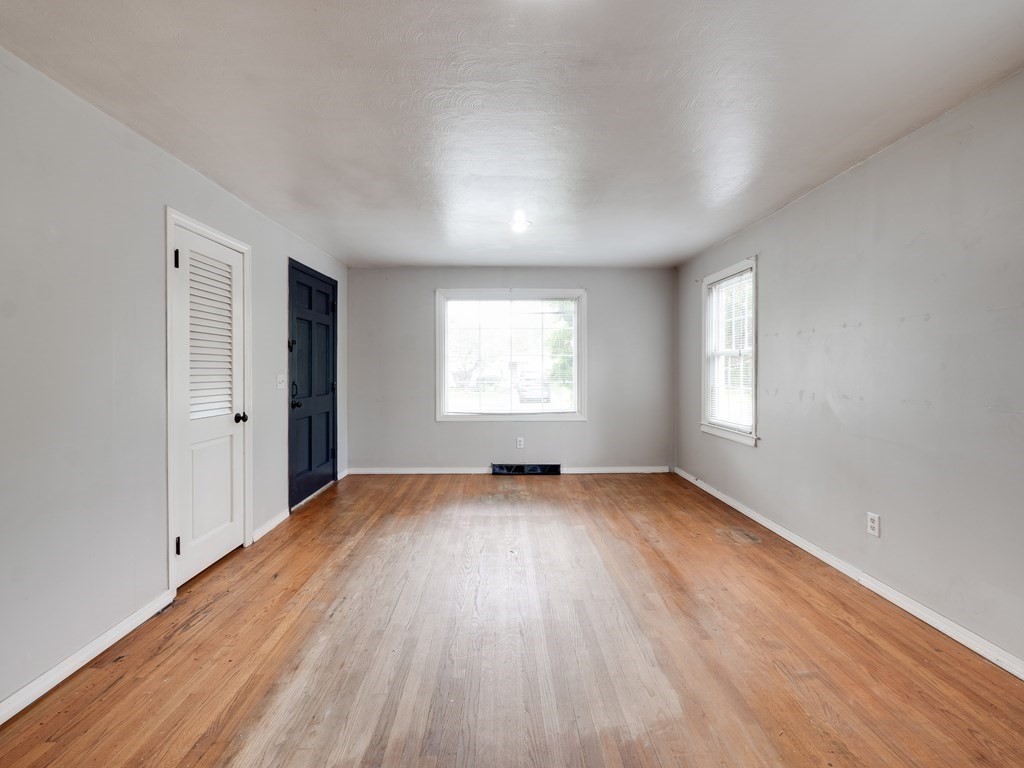 25 French Street Springfield, MA 01104 - Photo 12 of 16 an empty room with wooden floor and windows