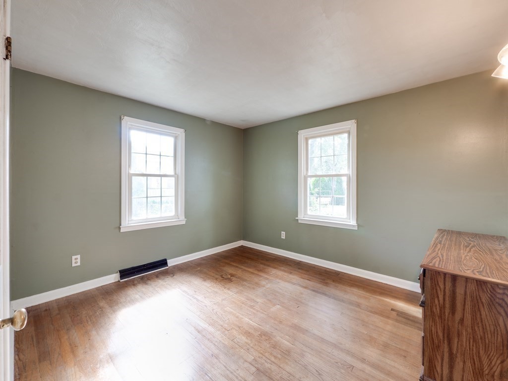 25 French Street Springfield, MA 01104 - Photo 14 of 16 an empty room with wooden floor and windows