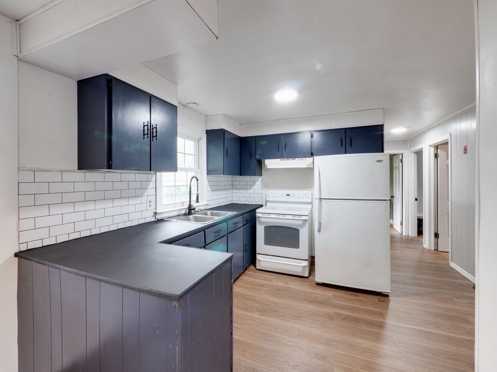 25 French Street Springfield, MA 01104 - Photo 4 of 16 a kitchen with refrigerator cabinets and wooden floor