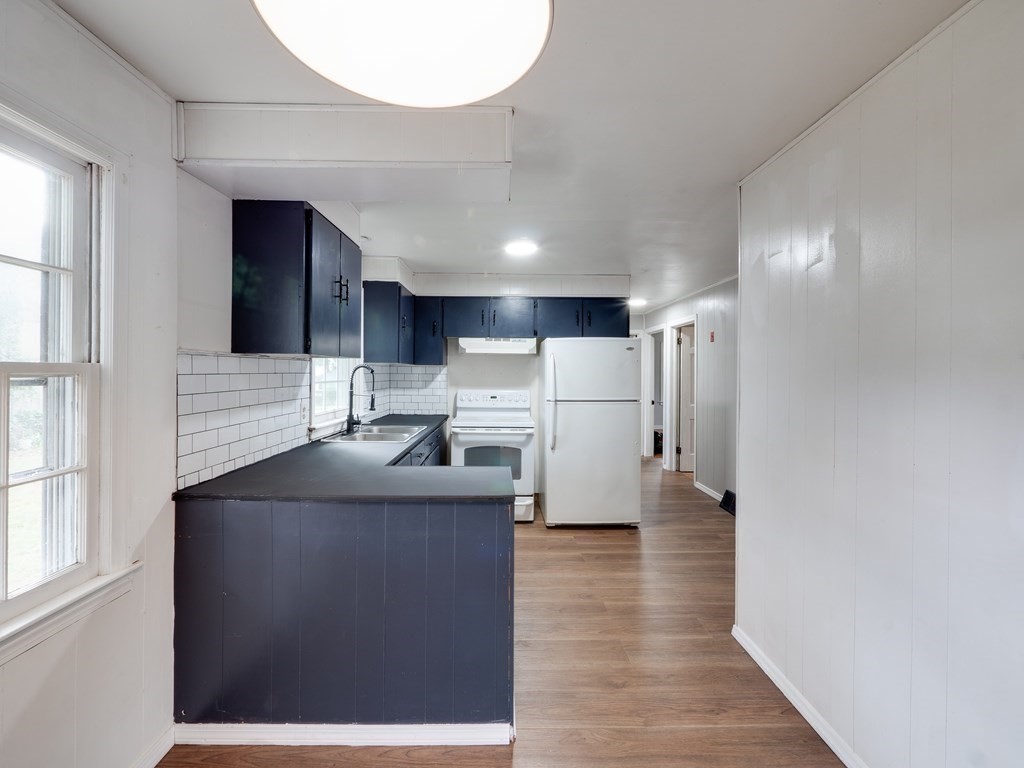 25 French Street Springfield, MA 01104 - Photo 7 of 16 a kitchen with stainless steel appliances granite countertop a refrigerator a sink dishwasher a stove and a refrigerator with wooden floor