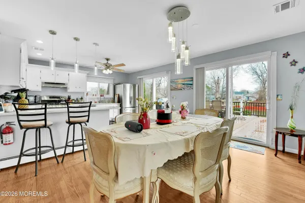 a view of a dining room with furniture window and wooden floor