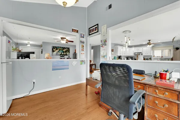a living room with stainless steel appliances kitchen island granite countertop furniture and a dining table