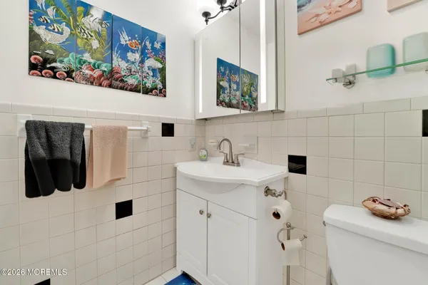 a bathroom with a sink mirror and vanity