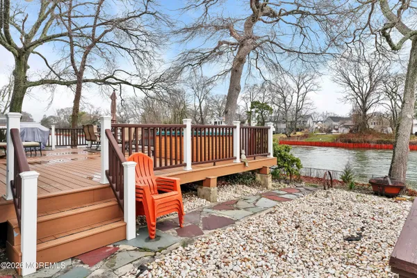 a view of a house with a yard and wooden fence