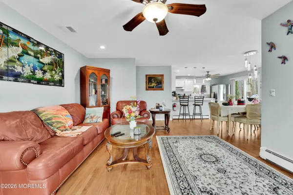 a living room with furniture and a wooden floor