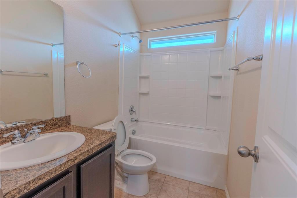 5157 Grayson Ridge Drive Fort Worth, TX 76179 - Photo 11 of 34 a bathroom with a granite countertop sink toilet and shower