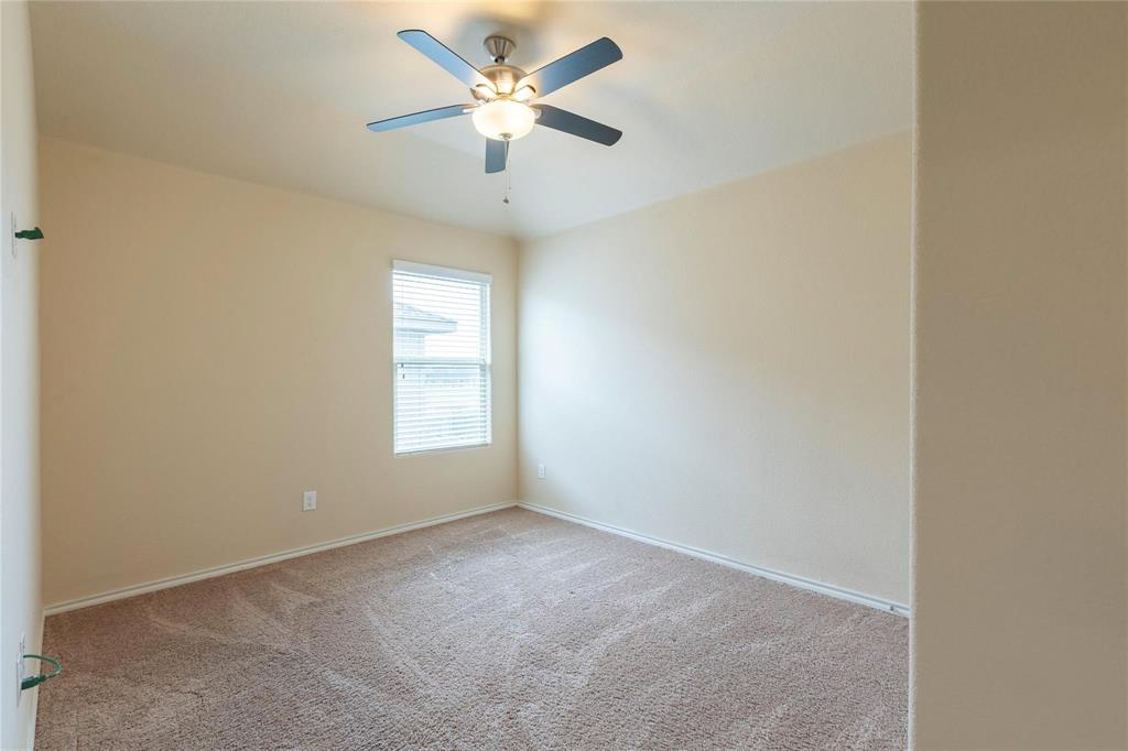 5157 Grayson Ridge Drive Fort Worth, TX 76179 - Photo 13 of 34 an empty room with a window and a fan