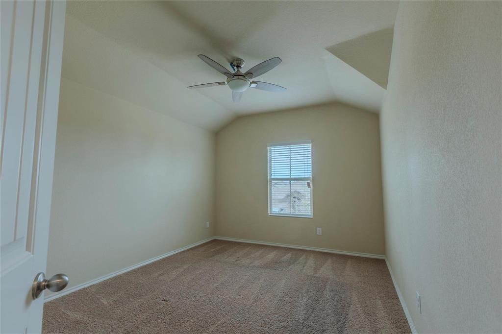 5157 Grayson Ridge Drive Fort Worth, TX 76179 - Photo 15 of 34 an empty room with a window and ceiling fan