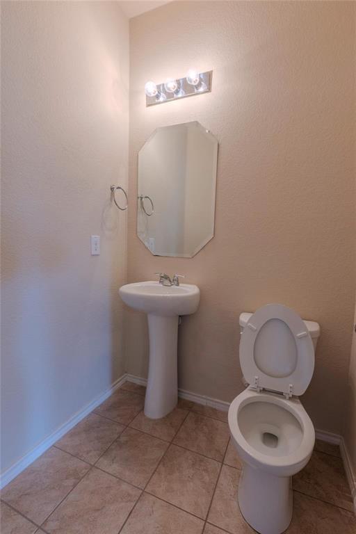 5157 Grayson Ridge Drive Fort Worth, TX 76179 - Photo 17 of 34 a bathroom with a toilet sink and mirror