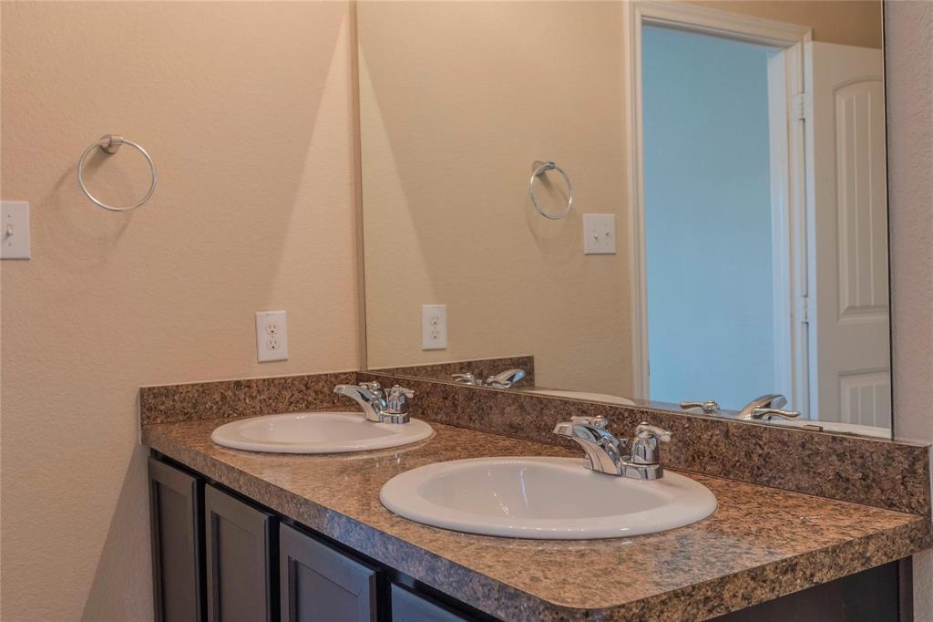5157 Grayson Ridge Drive Fort Worth, TX 76179 - Photo 19 of 34 a bathroom with a granite countertop sink and a mirror