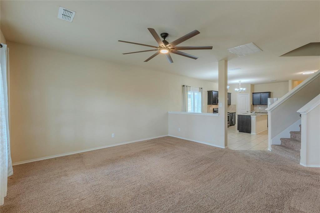 5157 Grayson Ridge Drive Fort Worth, TX 76179 - Photo 29 of 34 a view of a livingroom with a ceiling fan & a ceiling fan