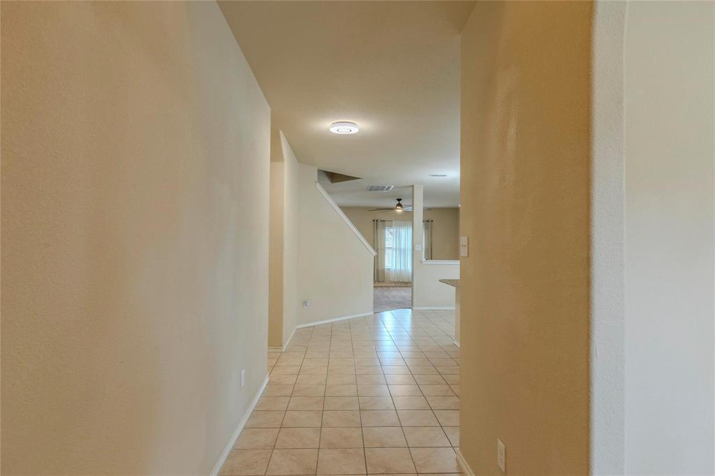 5157 Grayson Ridge Drive Fort Worth, TX 76179 - Photo 4 of 34 a view of a hallway with wooden shelves