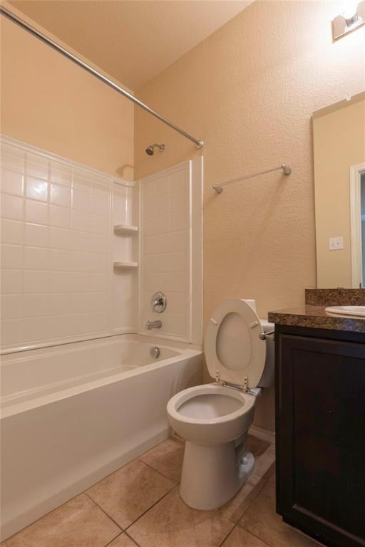 5157 Grayson Ridge Drive Fort Worth, TX 76179 - Photo 10 of 34 a bathroom with a toilet a sink and bathtub