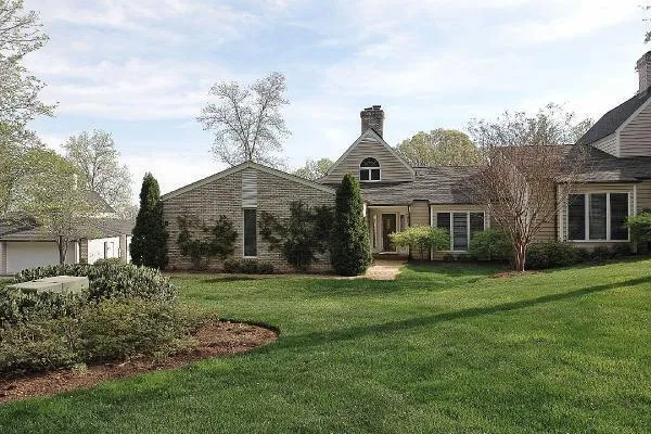a front view of a house with a garden