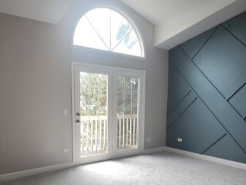 501 Leah Lane, Unit 2A Woodstock, IL 60098 - Photo 2 of 13 a view of an empty room with a window