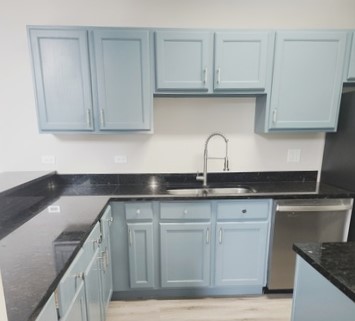 501 Leah Lane, Unit 2A Woodstock, IL 60098 - Photo 7 of 13 a kitchen with granite countertop a sink and cabinets