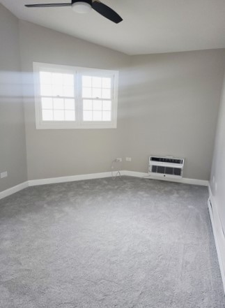 501 Leah Lane, Unit 2A Woodstock, IL 60098 - Photo 10 of 13 an empty room with windows